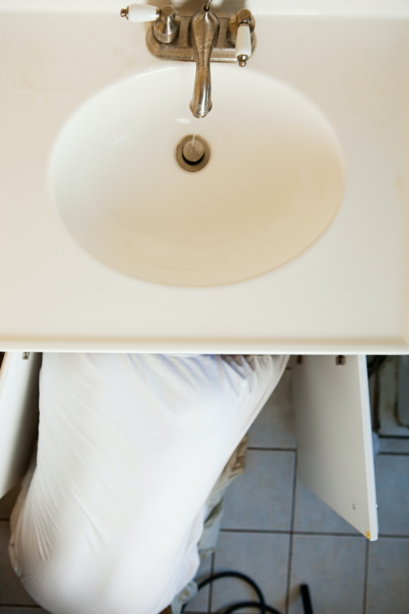Plumber repairing sink