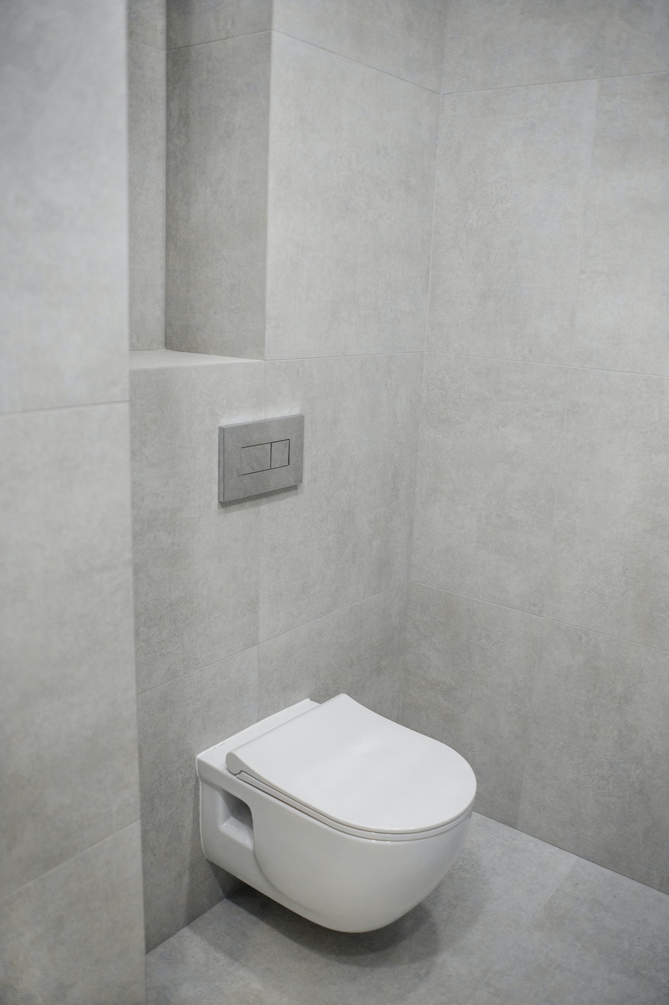 Toilet with built-in toilet in gray tones. The built-in toilet is made as installation, all elements